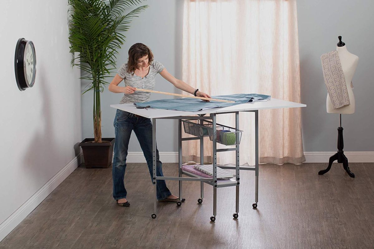 Sew Ready Studio Designs folding cutting table with storage bins and adjustable height