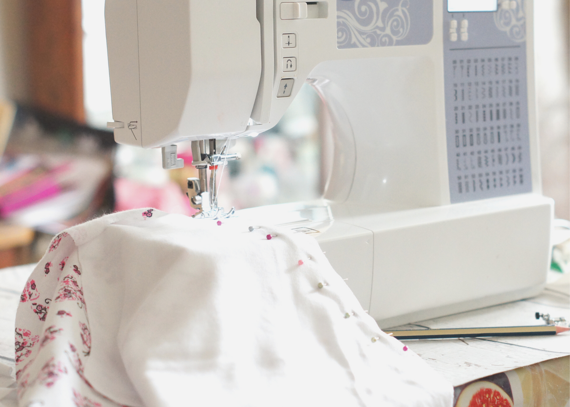 Beginner sewing setup with sewing machine, fabric, scissors, and thread, representing tips for learning to sew