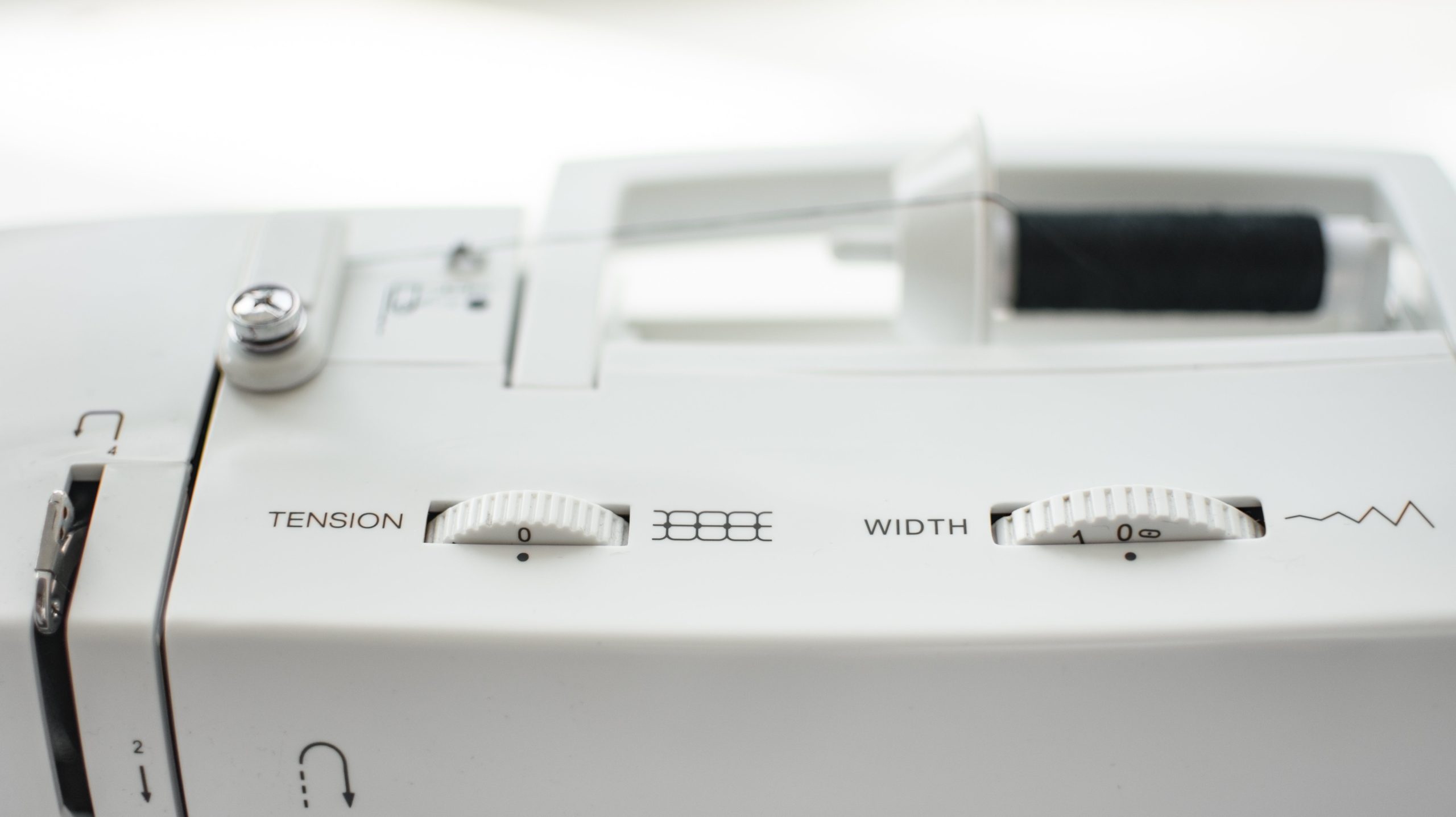 Adjusting sewing machine tension using the top thread and bobbin controls for perfect stitching