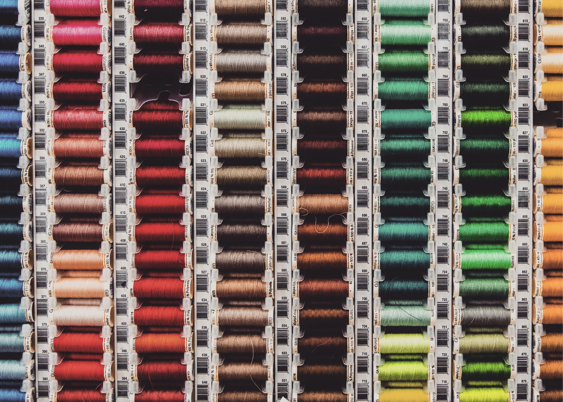 Spools of colorful sewing thread arranged on a craft table