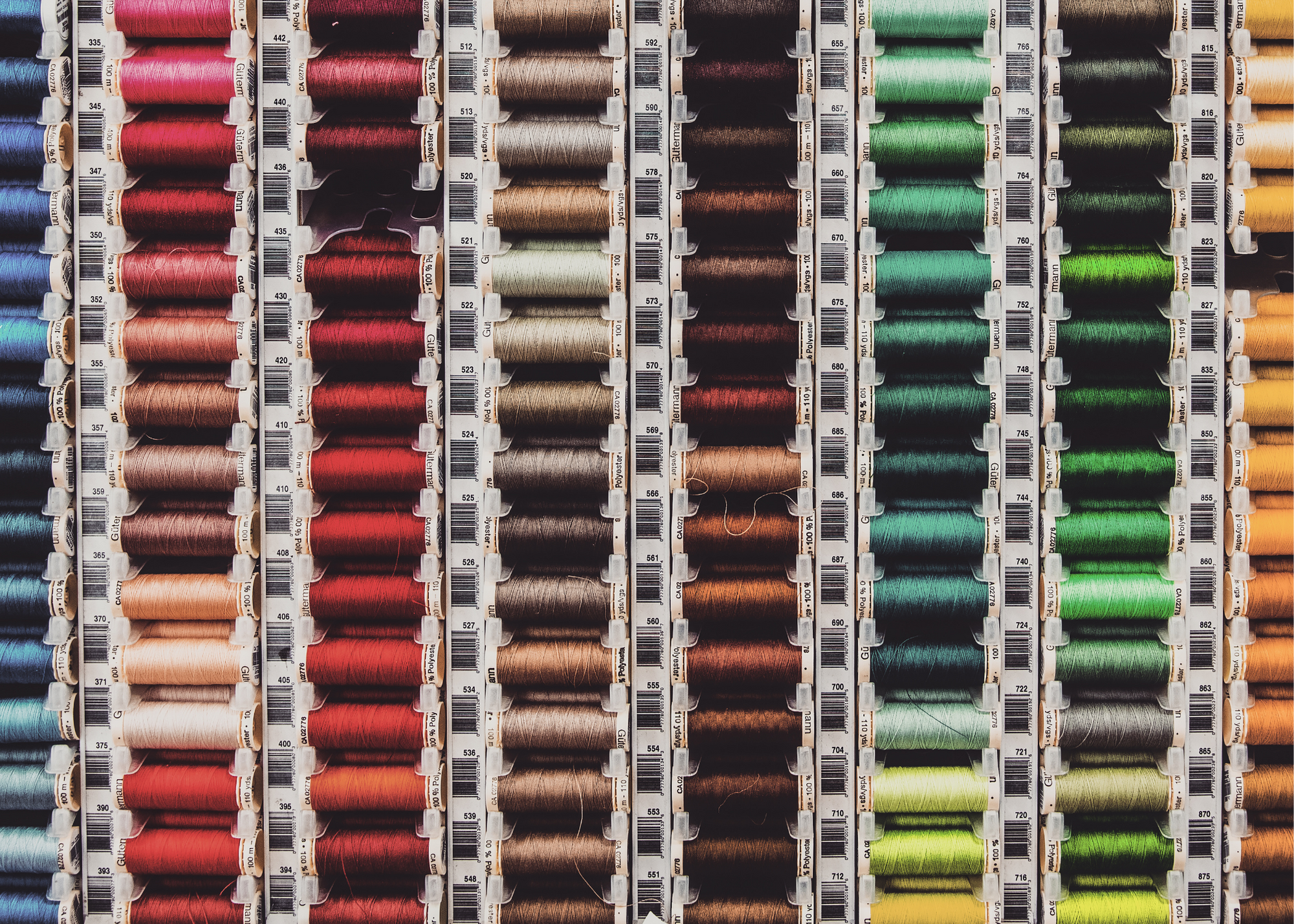 Spools of colorful sewing thread arranged on a craft table
