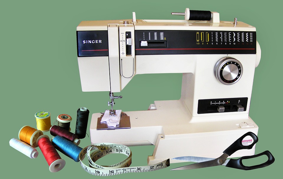 Sewing machine being serviced with tools for repair